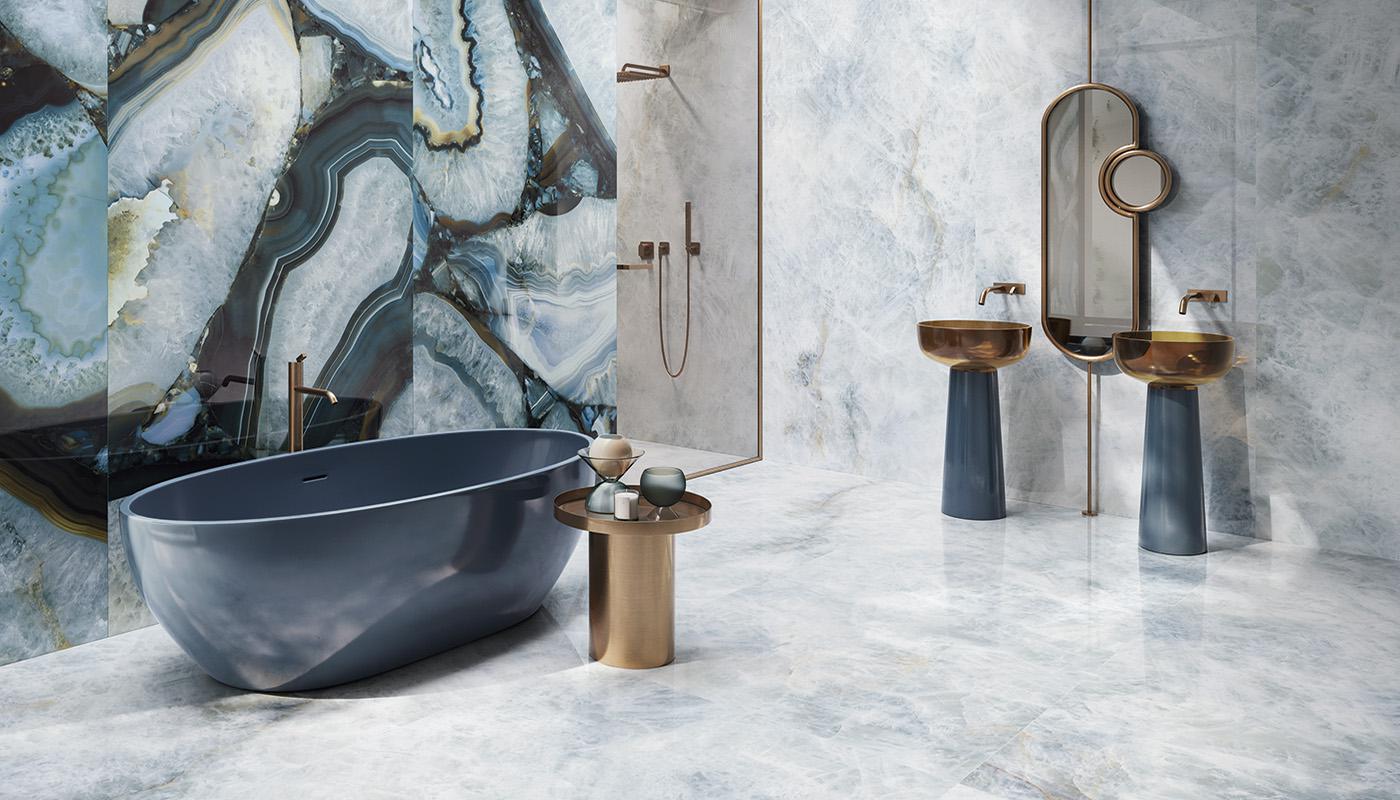 Luxurious bathroom with Emil Ceramica Tele Di Marmo Precious porcelain tile collection featuring marble-effect walls and flooring, modern freestanding bathtub, and elegant gold and black fixtures.