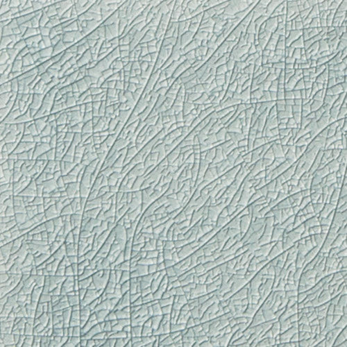 Light blue crackled texture ceramic tile from the Ocean Top Sail collection, showcasing subtle variations in hue and a unique glossy surface for elegant interior design.