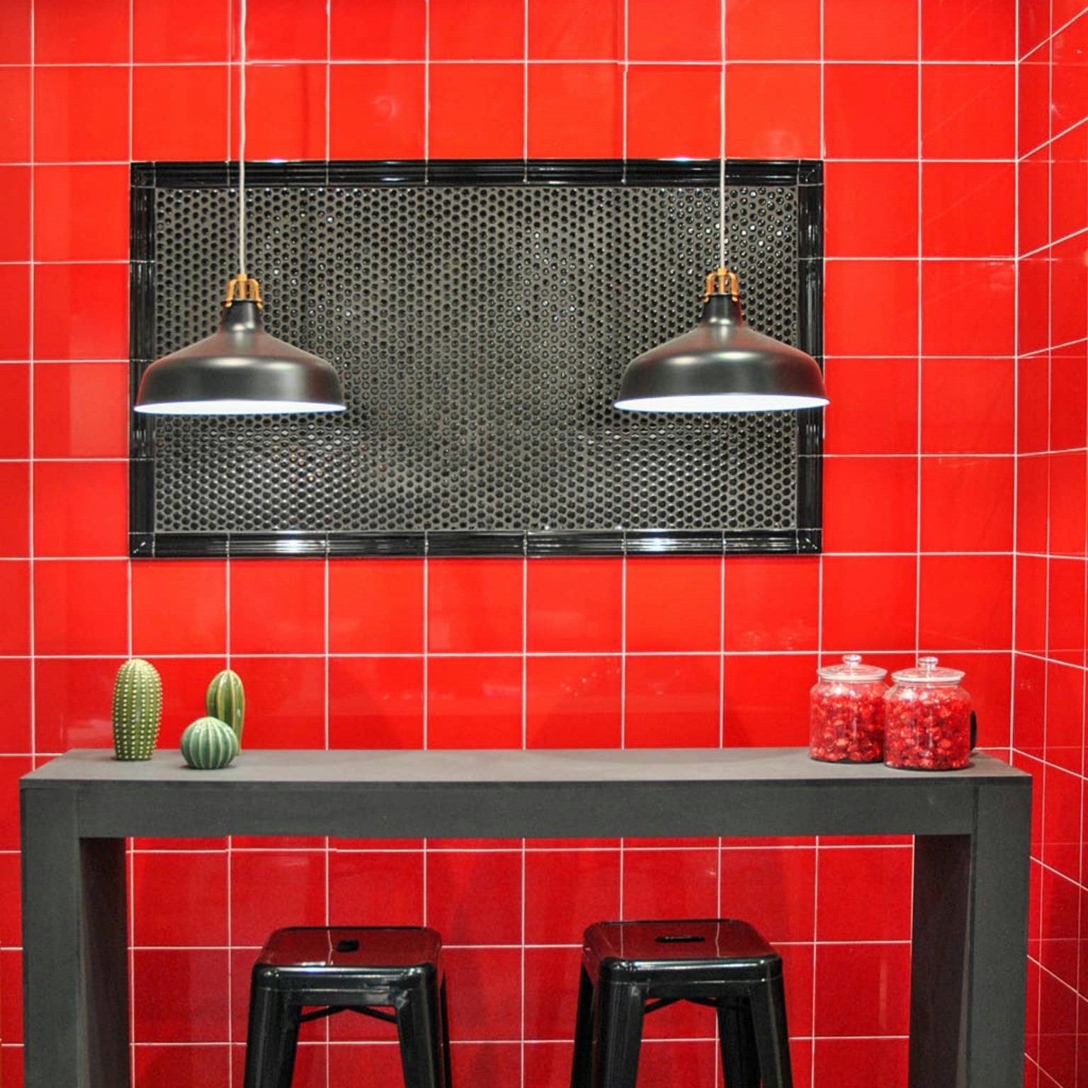 Modern bathroom vanity against a backdrop of Adex Riviera Ceramic Tiles in strong red, accented with a decorative mosaic border, showcasing the collection's sophisticated multi-tone glaze effect.