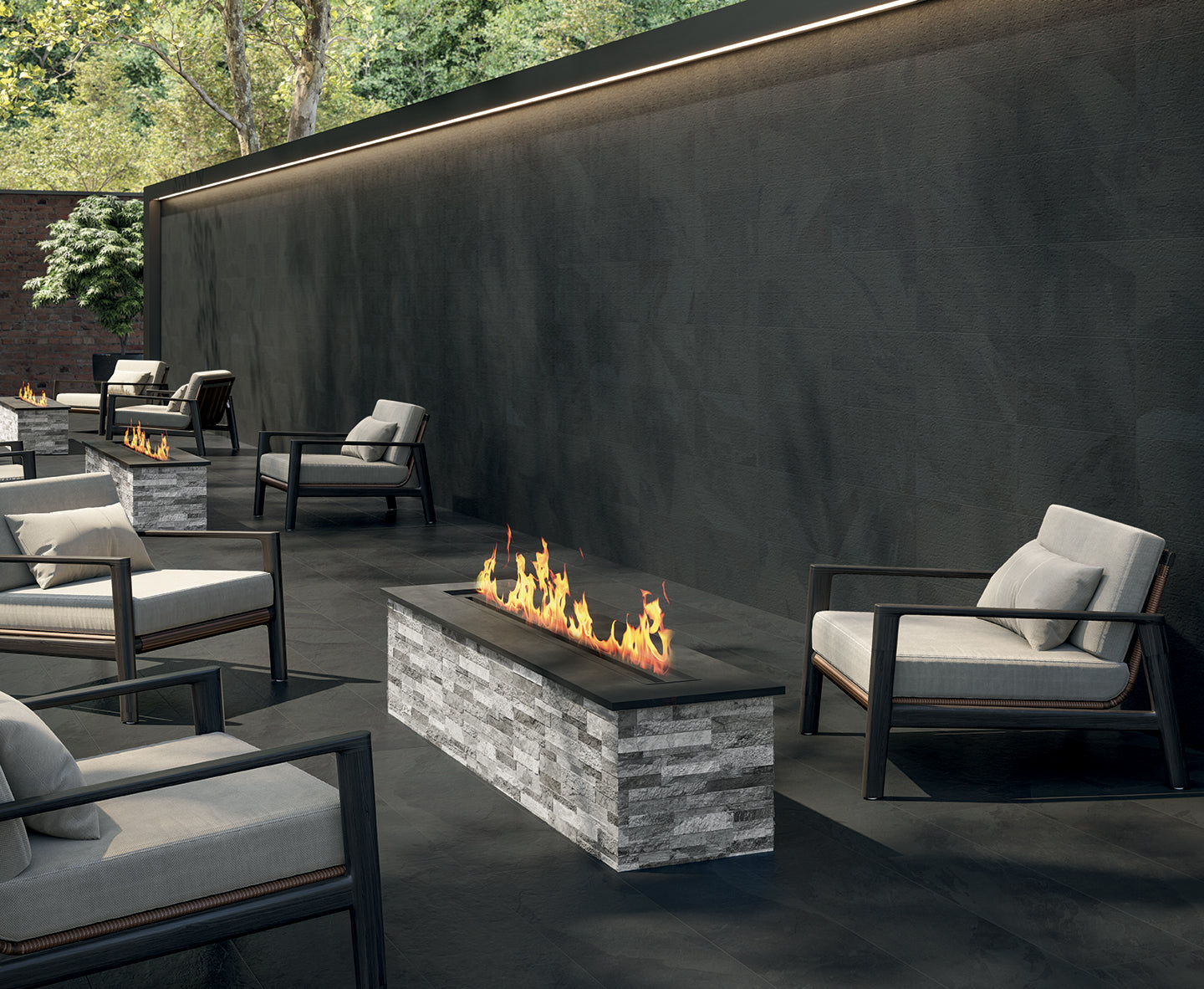 Luxurious porcelain tile collection from Surface Group featuring textured black tiles in an elegant outdoor patio setting with modern furniture and a fire feature.