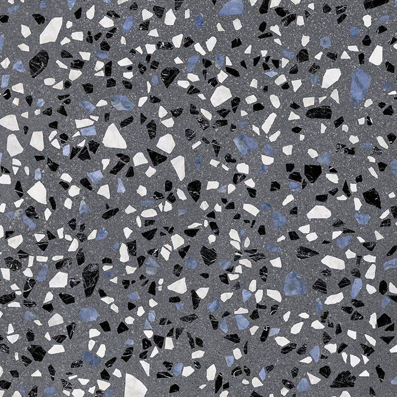 Close-up view of a porcelain tile with a terrazzo look, featuring scattered chips of white, black, beige, and blue stones embedded in a dark grey base.