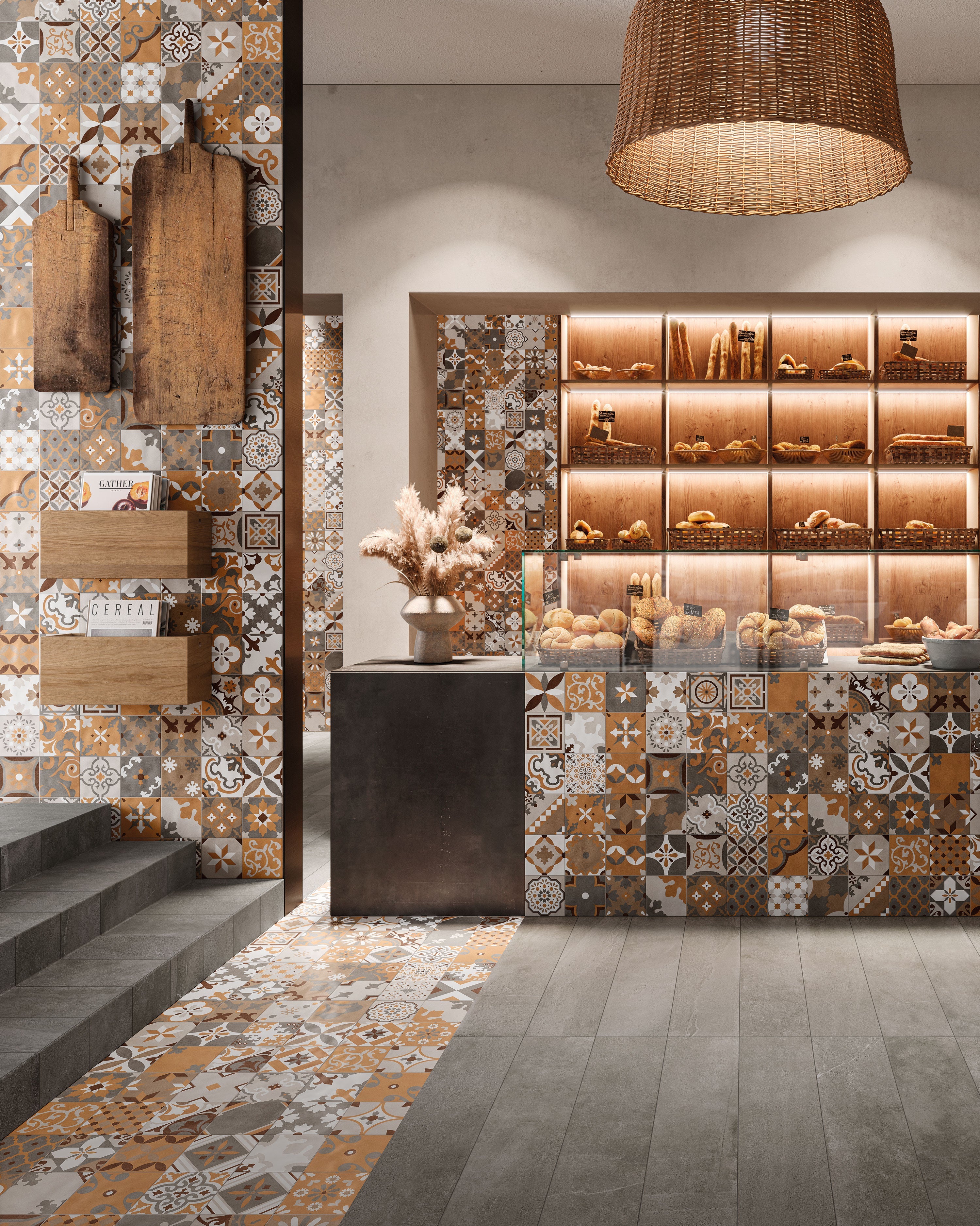 Porcelain tile collection from Surface Group featuring decorative patterned tiles in earth tones for flooring and wall cladding in a modern kitchen setting with wooden shelves and wicker lighting.