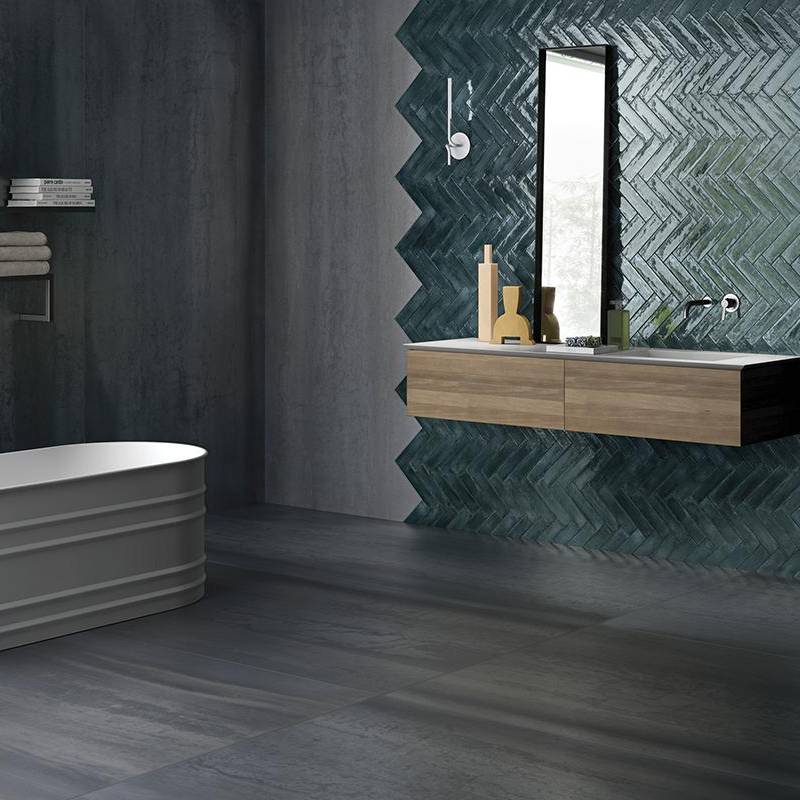 Metallic finish porcelain tiles with contemporary herringbone pattern in a modern bathroom setting.