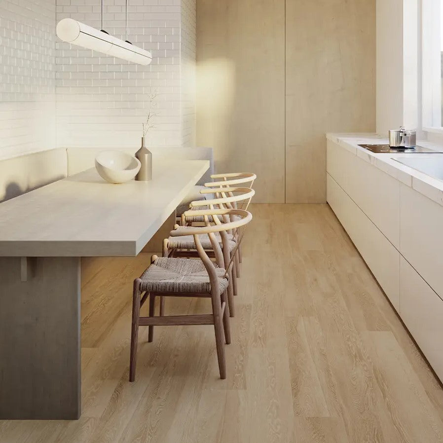 Light wood-look porcelain tile flooring in a modern kitchen with white countertops, minimalist furniture, and warm natural light.
