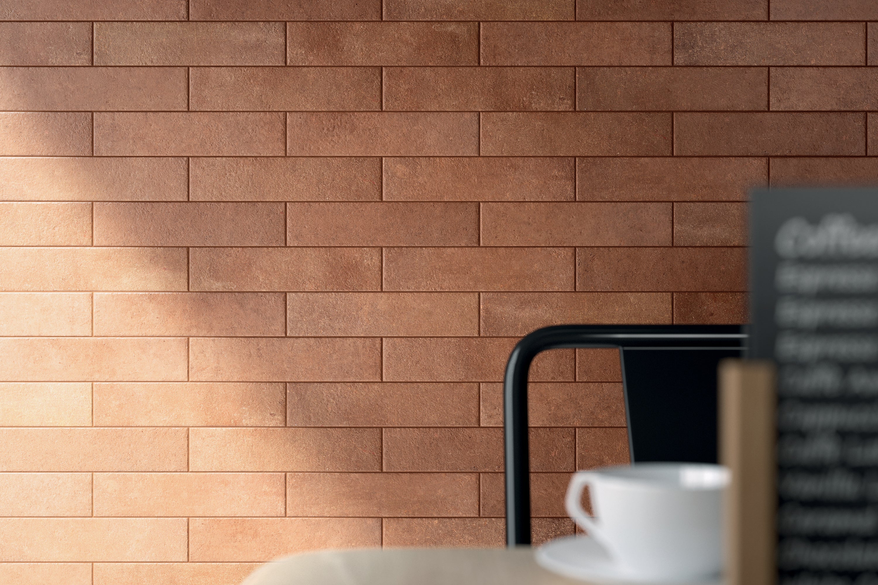 Porcelain tile collection from Surface Group featuring Soho brick-look tiles in warm earth tones displayed in a stylish interior setting.