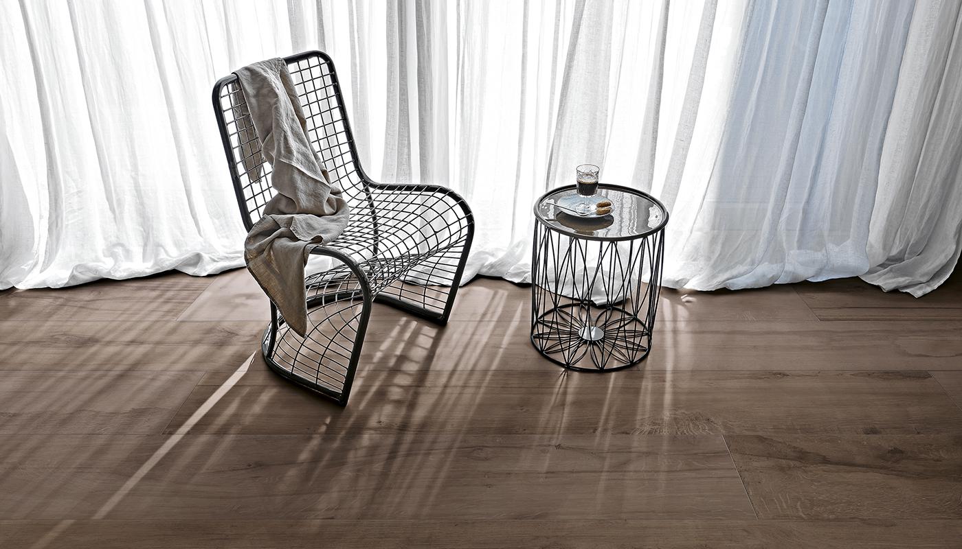 Elegant interior with Millelegni Remake Italian porcelain tile flooring, modern wire chair, and side table by sheer curtain window.