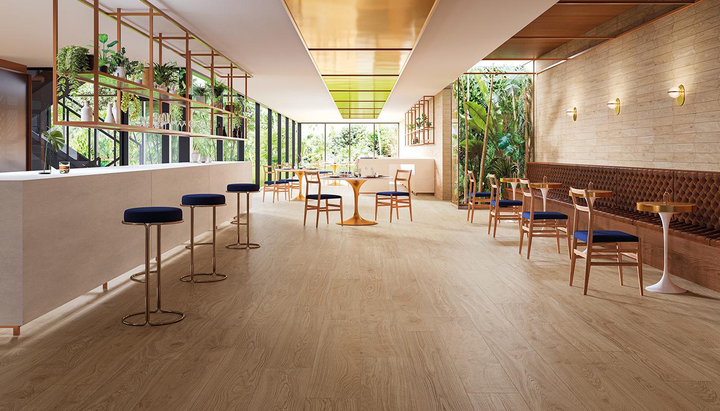 Modern interior design featuring Emilceramica Mimesis Italian porcelain tile flooring in a spacious, well-lit room with wooden accents and greenery