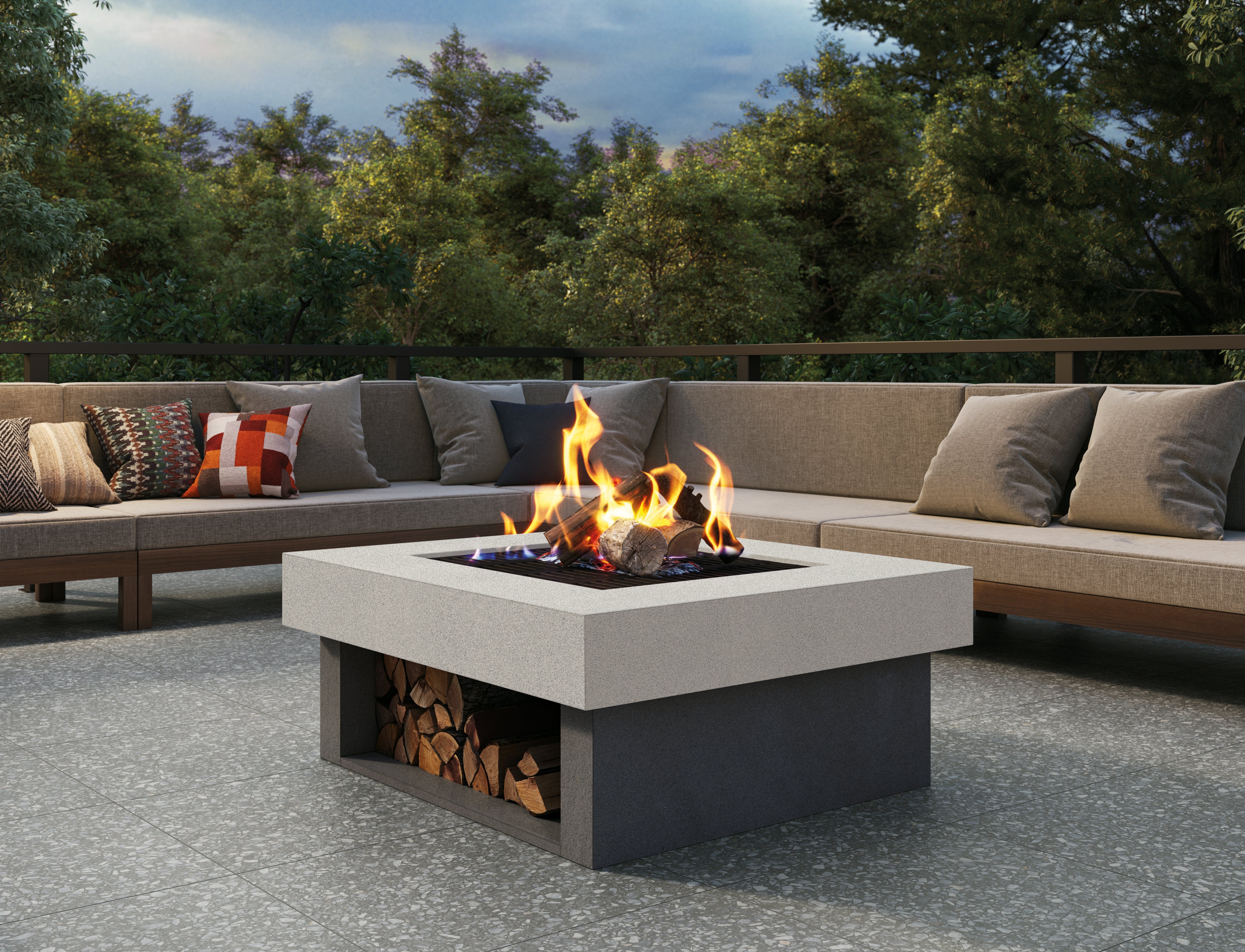 Terrazzo porcelain tile collection by Surface Group featuring modern outdoor patio with fire pit and forest background