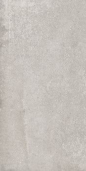 Matte beige porcelain tile with subtle concrete texture and refined rectified edges, evoking understated luxury and tactile depth.