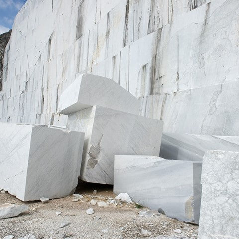 large raw blocks of natural stone laying in the quarry