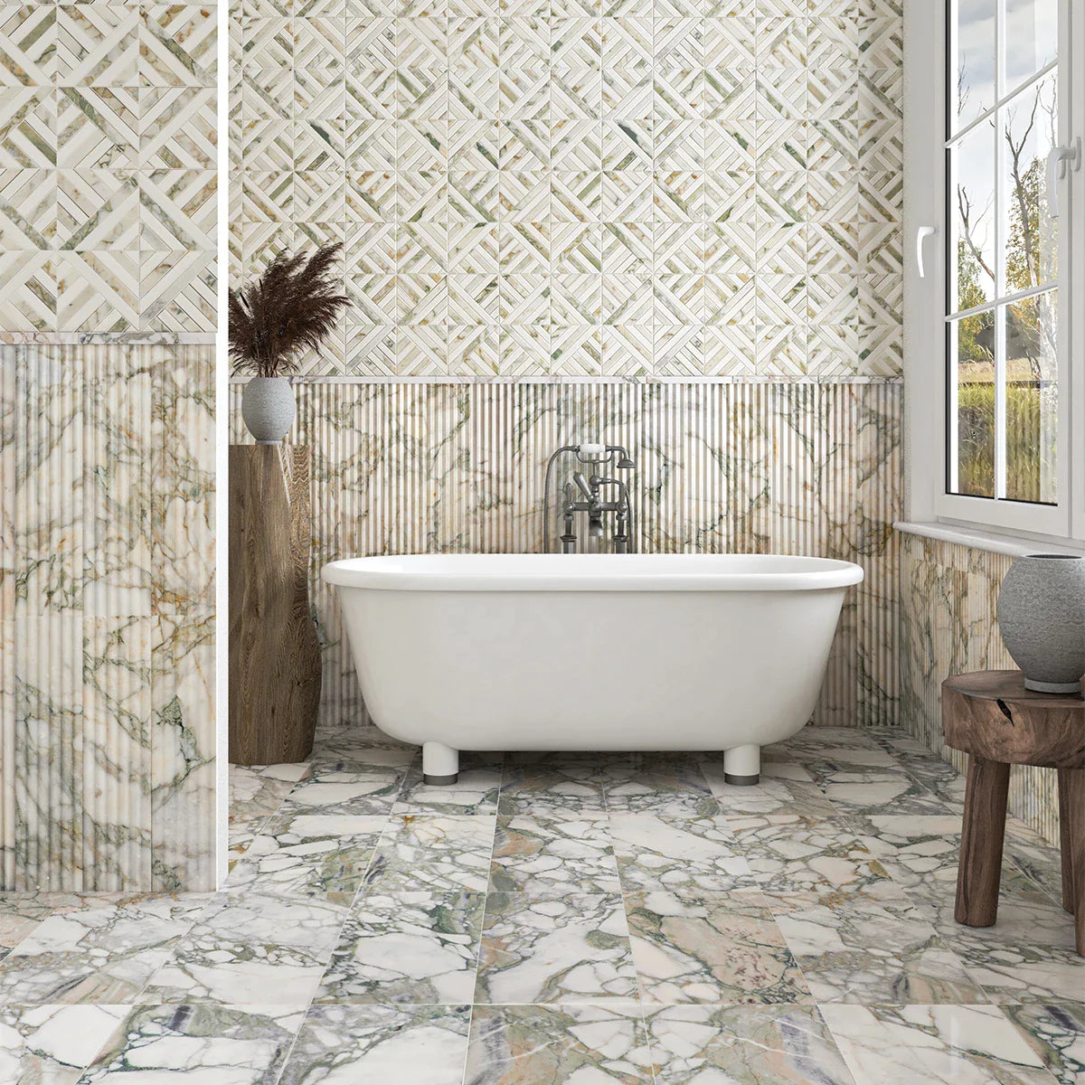 Elegant bathroom with white freestanding tub, Calacatta green marble walls, large marble tiles, wooden stool, vase, dried grasses, and natural light.