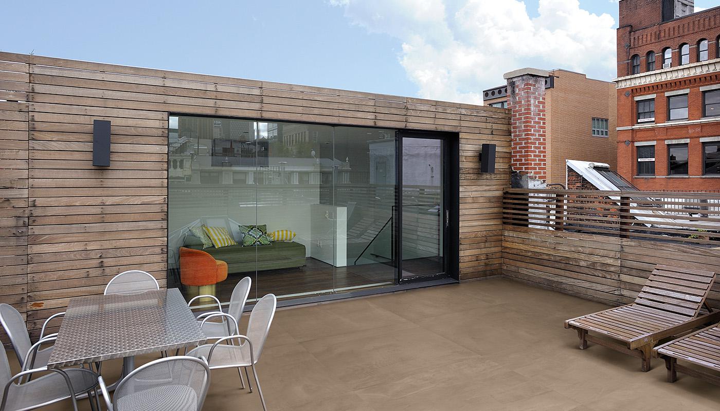 Emil Viva 99 Volte porcelain tile collection showcased in a modern outdoor terrace with wooden privacy fence, stylish patio furniture, and sliding glass door.