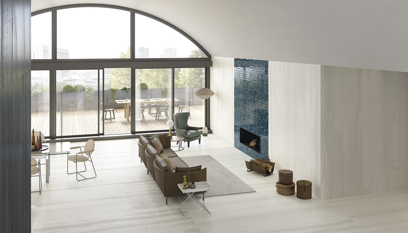 Modern minimalist living room with Emil Viva Metallica porcelain tile flooring, featuring a fireplace, large arched window, and elegant furniture.