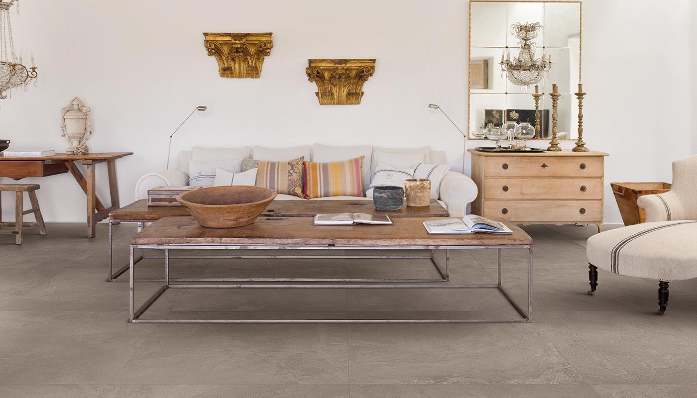 Elegant living room interior showcasing Emil Viva Plus porcelain tile flooring with vintage furniture and decorative elements.