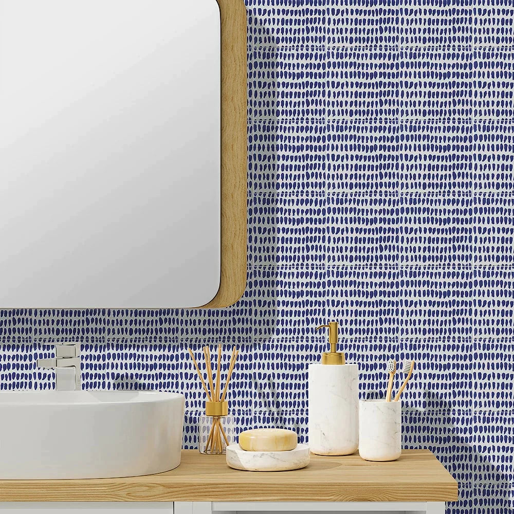 Bright and refreshing bathroom featuring a vibrant blue Sister Parish Ceramic wall with a playful dotted pattern, paired with a modern white basin and natural wood accents, creating a lively yet serene ambiance.