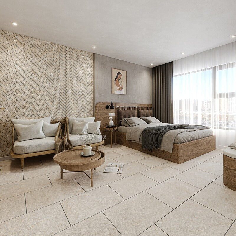 Modern bedroom with beige tiles, wooden bed and coffee table, light sofa, herringbone-patterned wall, large window with white curtains, neutral tones.