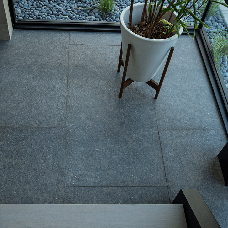 An array of blue limestone tiles and slabs from the Blue Limestone Collection, displaying a spectrum of blue shades and unique natural patterns, ideal for adding a touch of serene elegance to any interior design project.