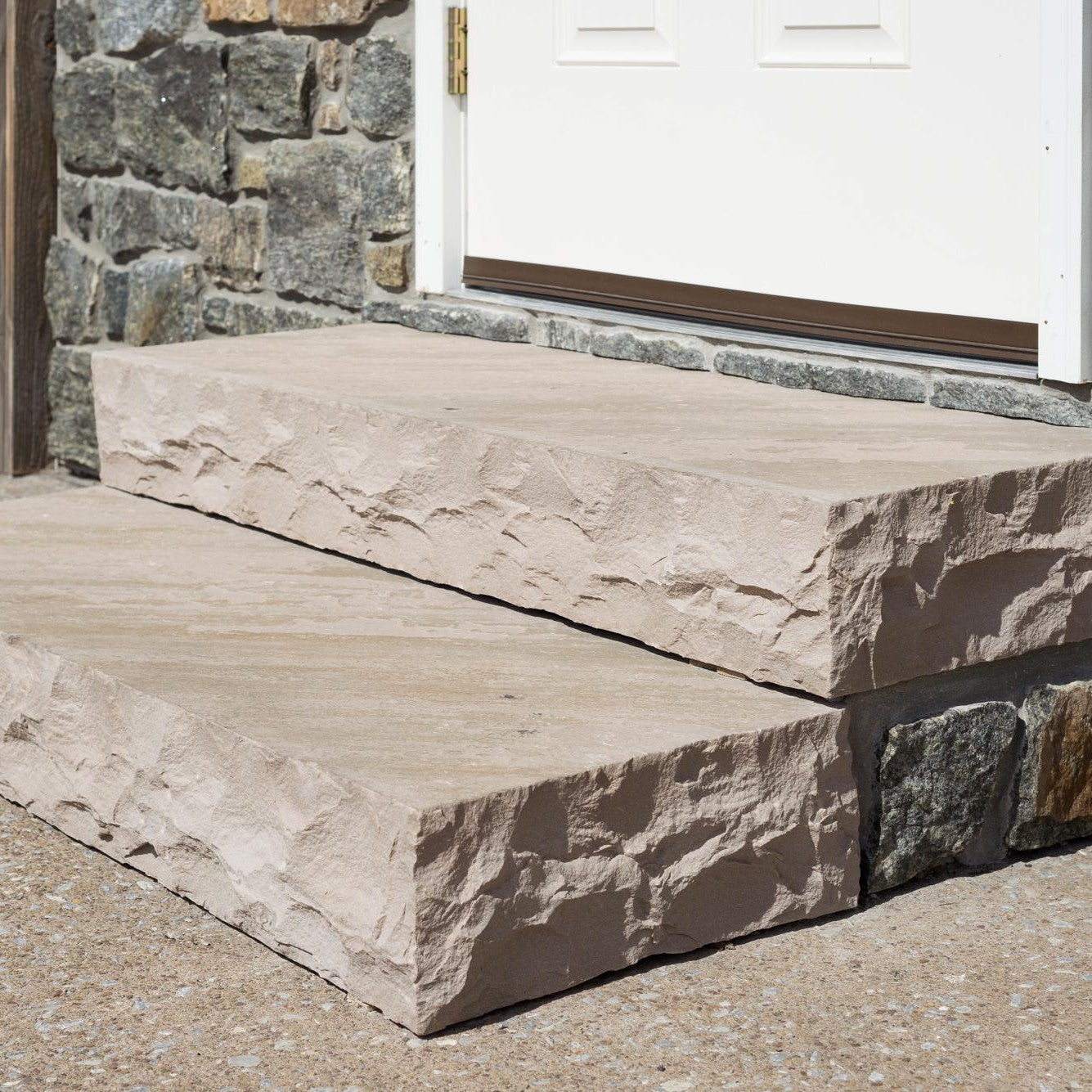 Assorted pieces from the Classic Series Flagstone Collection, showcasing the rustic charm of natural cleft tops and hand-cut rockfaced edges for authentic landscaping designs.