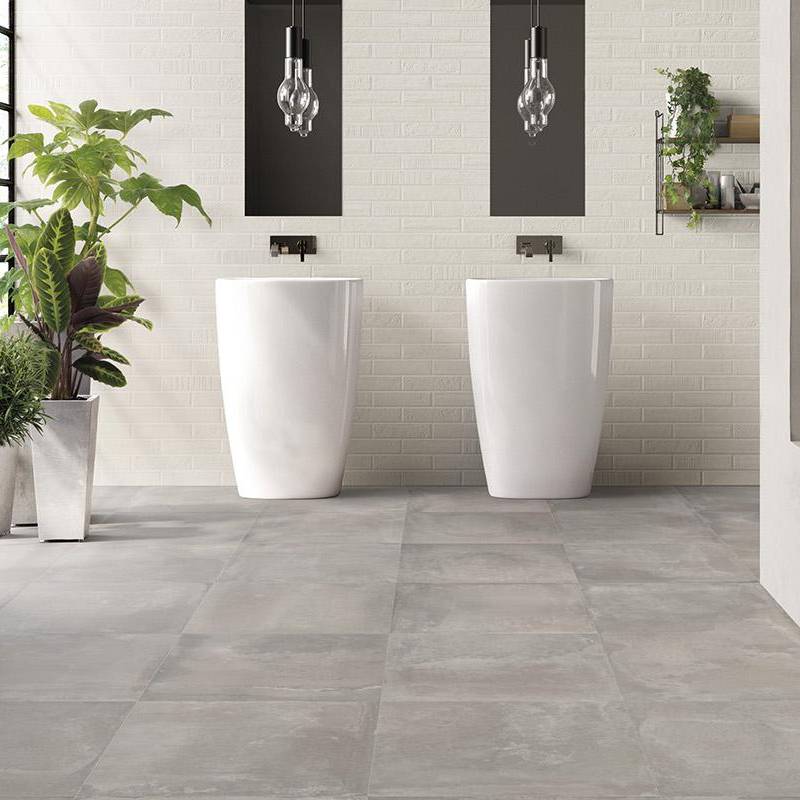 Porcelain tile with a clay ceramic look in a modern bathroom setting with white fixtures and plants