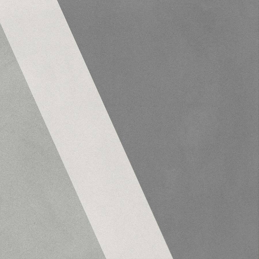 Porcelain tile with a mix of light and dark gray shades in a patchwork design from Surface Group.