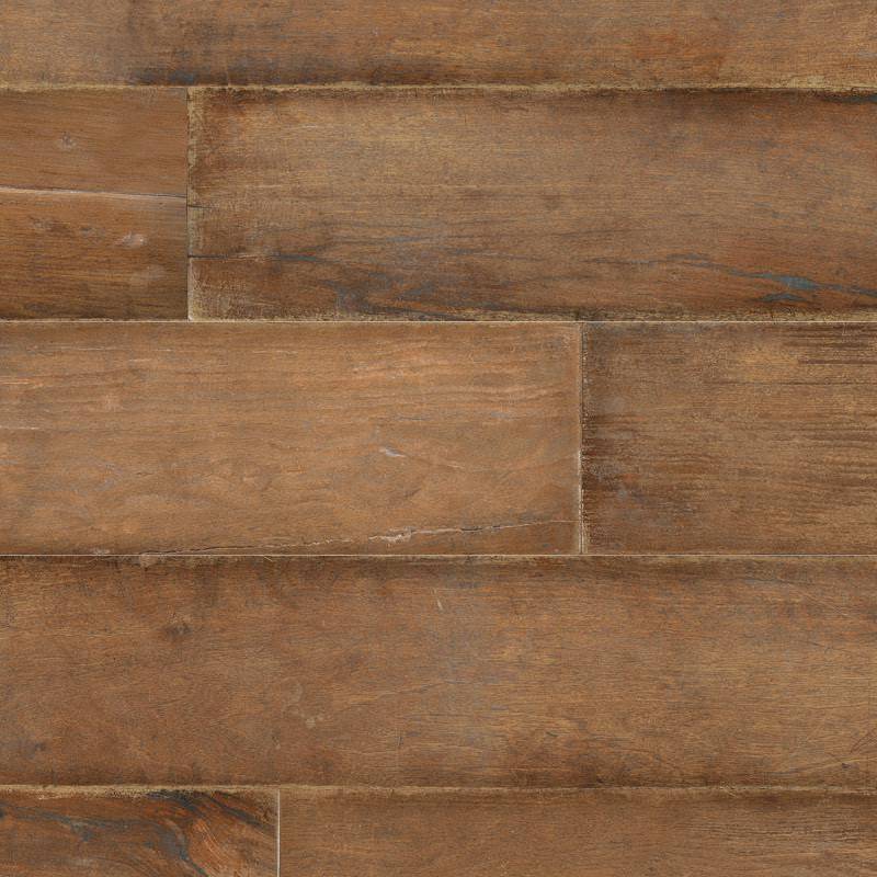 A close-up of porcelain tiles designed to mimic the appearance of brown wooden planks with realistic wood grain patterns and textures.