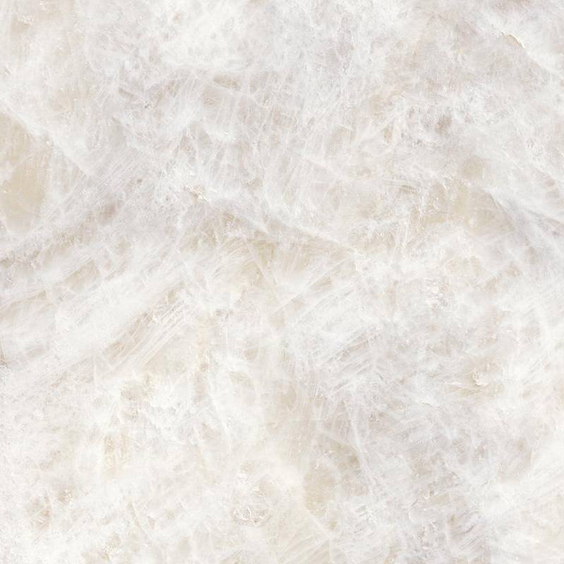 A close-up image of a porcelain tile with a marble effect, showcasing a mix of translucent and white areas interlaced with amber and beige veins that give it an intricate and luxurious appearance.