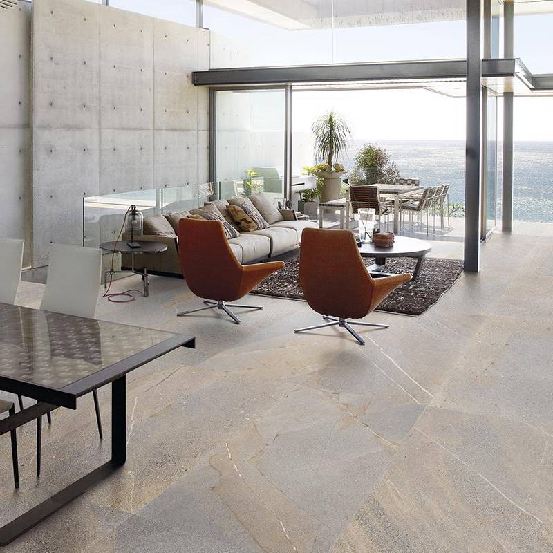 High-quality granite stone-look porcelain tile in a modern living room with large windows and stylish furniture
