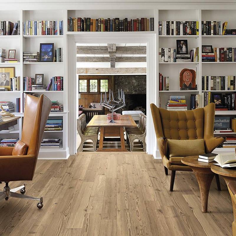 Alt text: "Elegant home library room with larch wood-look porcelain tile flooring and a cozy reading nook flanked by floor-to-ceiling bookshelves."