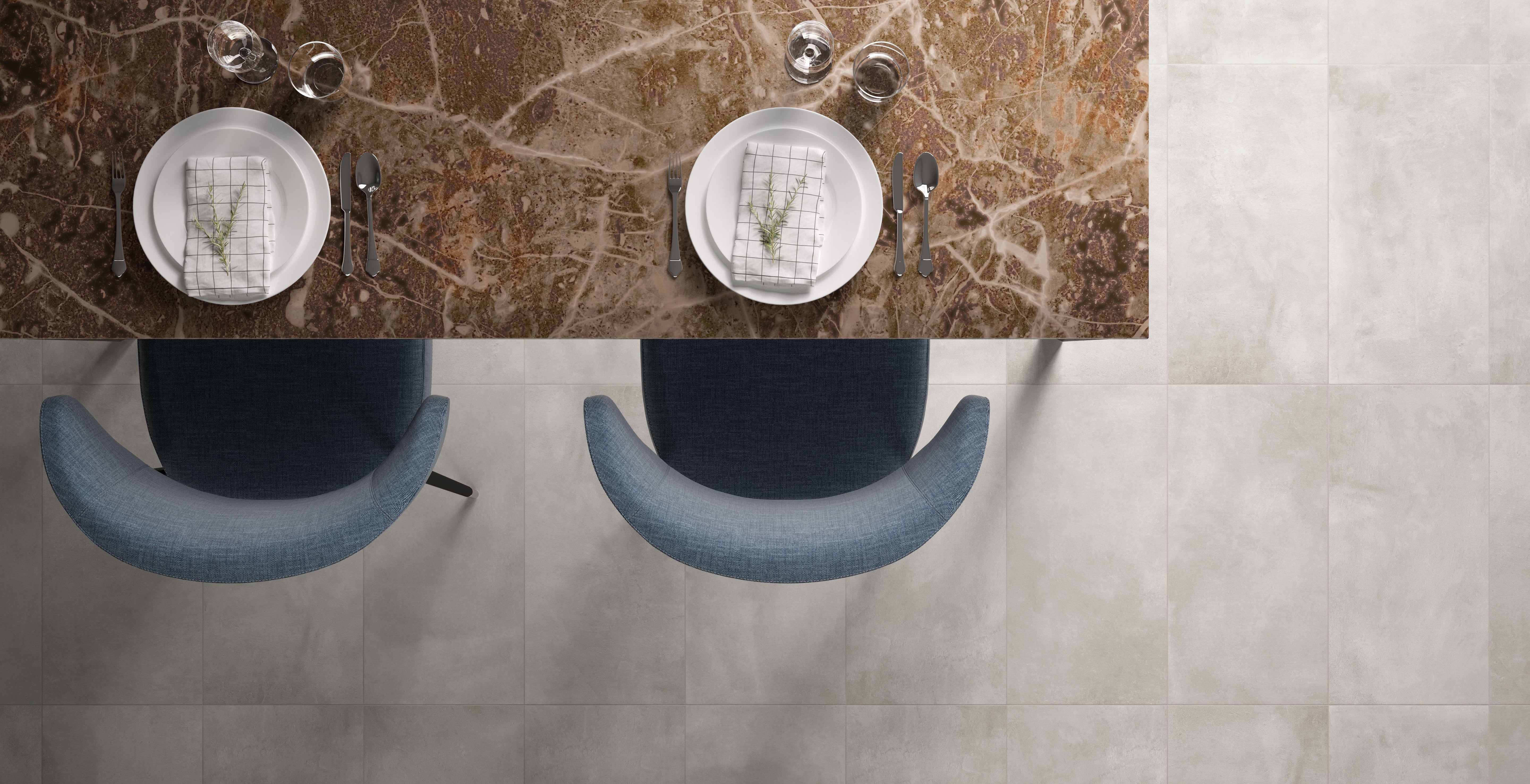 Luxurious New York porcelain tile collection by Surface Group, featuring elegant marble design in a modern bathroom setting with stylish tableware and plush seating.