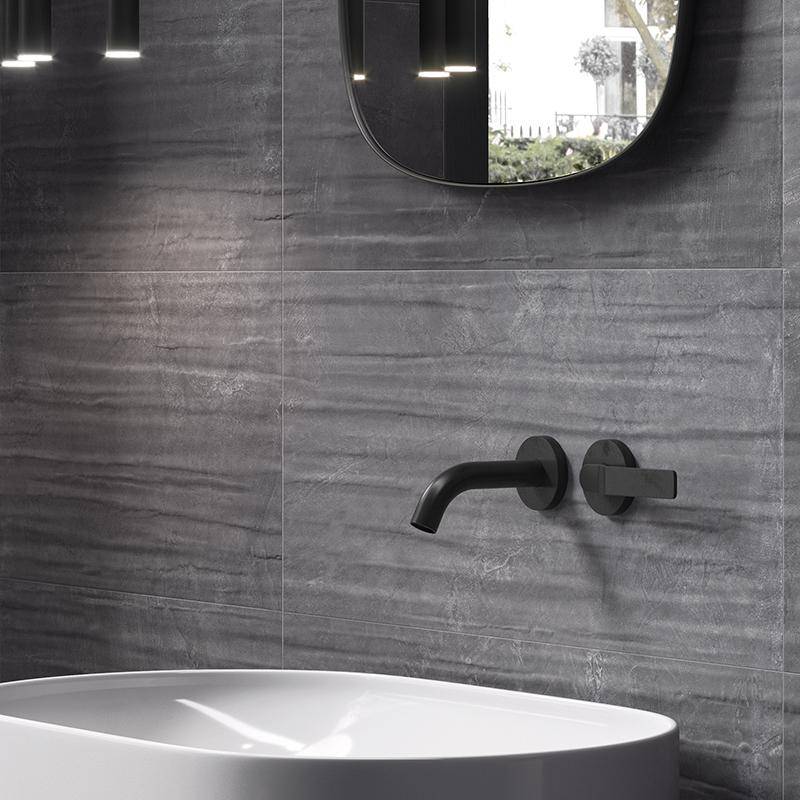 Modern resin-look grey porcelain tile on bathroom wall with elegant round mirror and white basin
