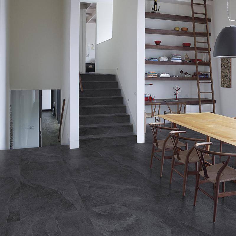 Modern minimalist dining room with slate stone-look porcelain tile flooring