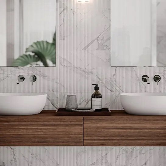 Elegant modern bathroom featuring Anatolia Raffino porcelain tile collection with marble design, showcasing dual vessel sinks on a wooden vanity.