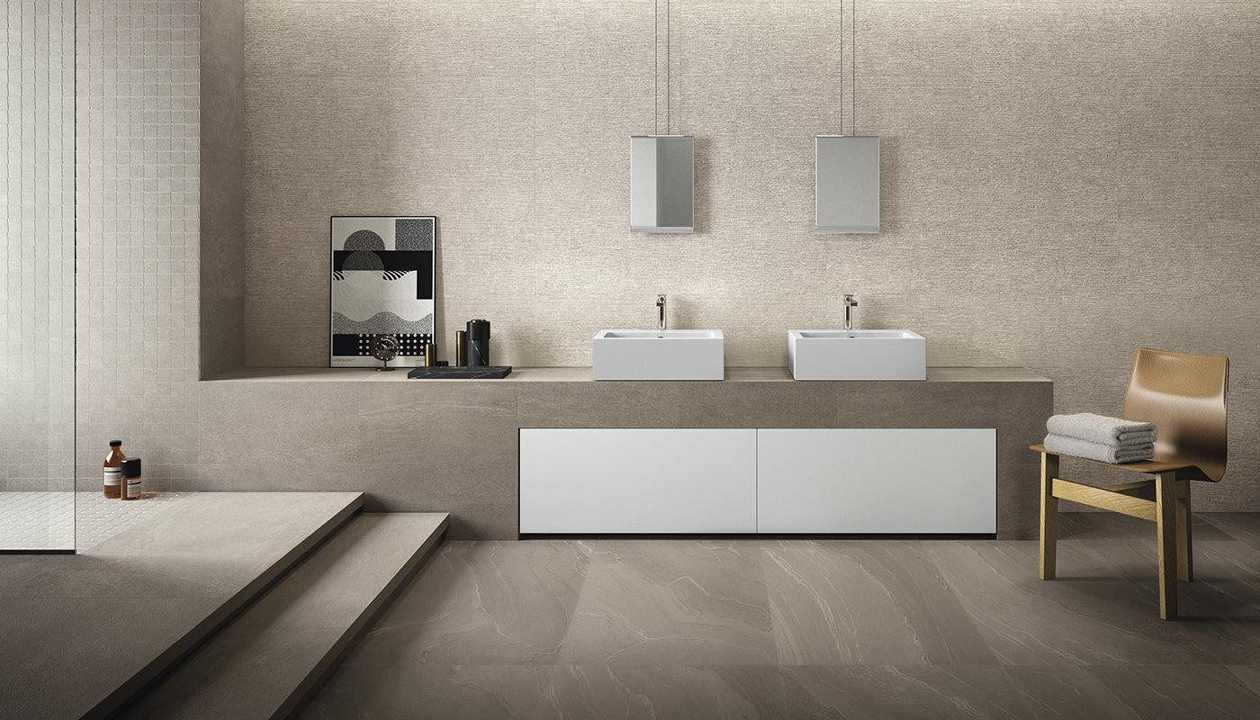 Elegant modern bathroom featuring Emil Ergon Stone Talk Italian porcelain tile, with dual sinks, wall-mounted mirrors, and minimalist decor.