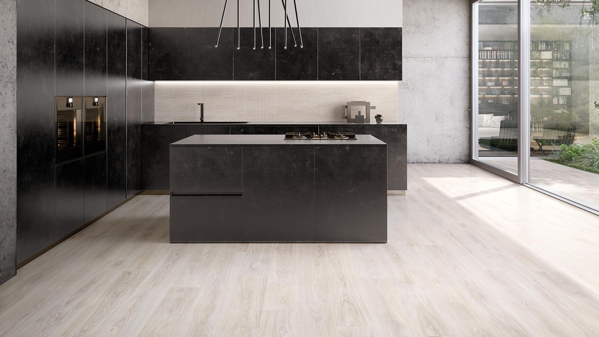 Emil Ergon Woodtouch Italian porcelain tile collection in a modern kitchen with light wood effect flooring, dark matte island, and black wall panels.