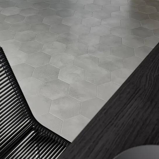 Hexagonal wool-look porcelain tiles laid out on a floor, transitioning from a lighter to darker shade.