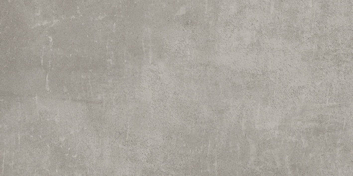 Handcrafted concrete-look porcelain tile in soft pebble gray with delicate reliefs and a refined matte finish for serene interiors.