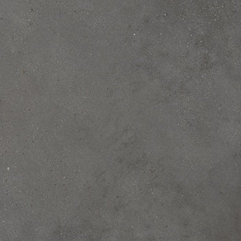 Dark gray porcelain tile with a matte, textured finish, evoking the raw elegance of sedimentary rock and urban sophistication.