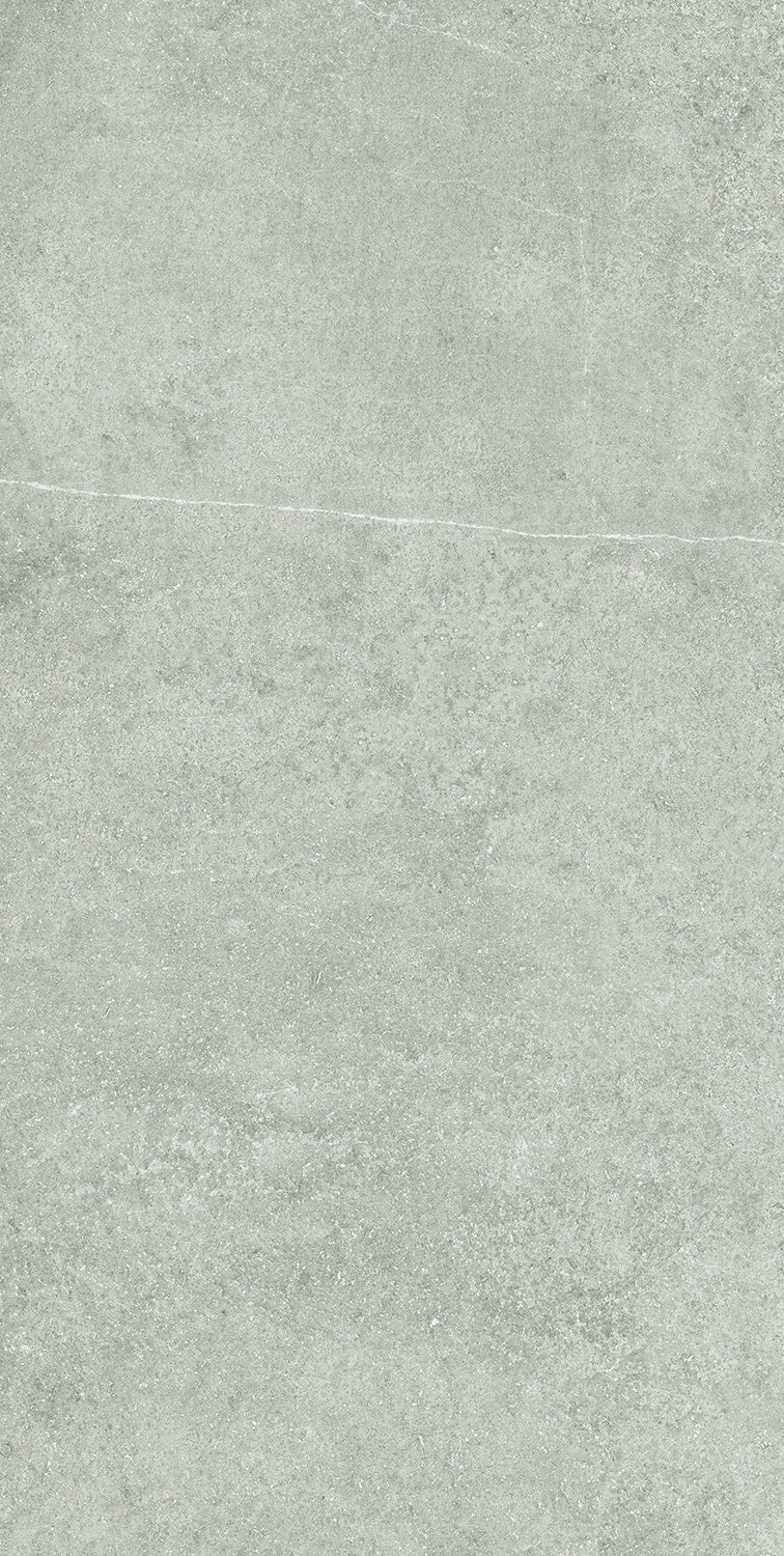 Matte beige porcelain tile with subtle concrete texture and refined rectified edges, evoking understated luxury and tactile depth.