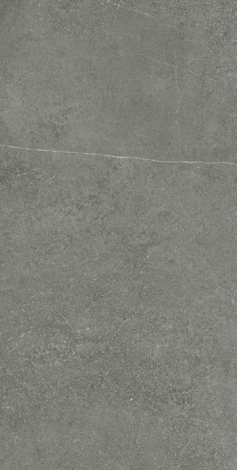 A textured matte gray porcelain tile with a refined concrete aesthetic and rectified edges for seamless luxury interiors.