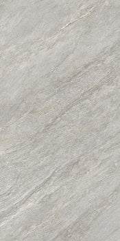 Rectified matte porcelain tile in soft gray quartzite, evoking primordial serenity with a full-body depth for intimate modern spaces.