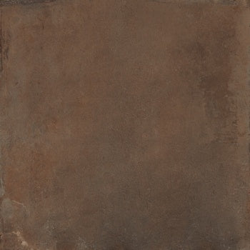 A rich, dark brown porcelain tile with a warm terracotta-inspired hue and matte, oxidized finish, evoking handcrafted Tuscan elegance.