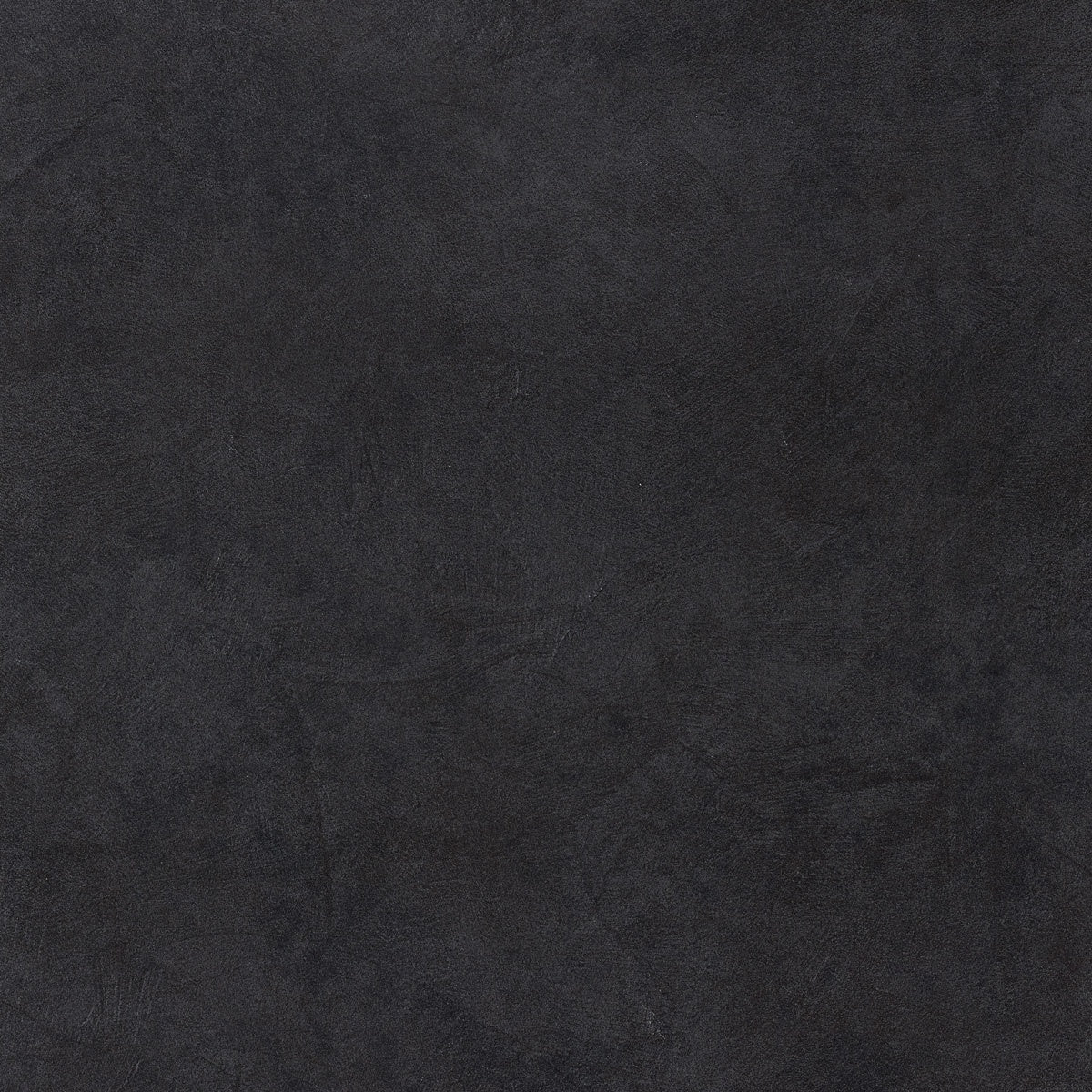 Black resin-inspired porcelain tile with a matte, 3D-textured surface, exuding contemporary minimalism and urban sophistication.