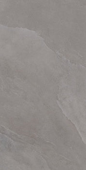 Luxurious slate-look porcelain tile with soft ripples and weathered furrows in a serene gray, evoking stone forest mystique. Matte, textured, refined.
