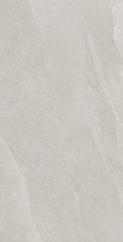 A textured porcelain tile with soft ripples and weathered slate tones, evoking serene stone forests in a minimalist, organic design.