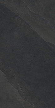 Black porcelain tile with a matte, bush-hammered slate texture, evoking weathered stone with soft ripples and organic furrows.
