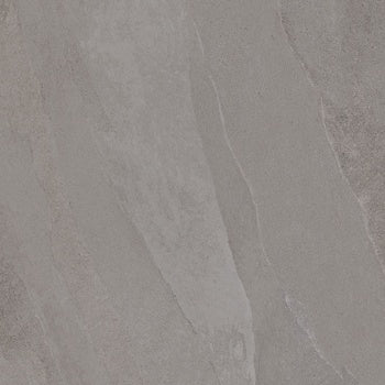 Soft gray porcelain slate tile with weathered furrows and subtle ripples, evoking the raw elegance of a stone forest. Matte, textured, and timeless.