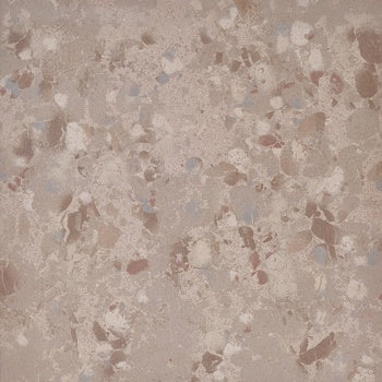 A textured terrazzo-effect porcelain tile with a semi-matte finish, blending beige tones and raw material chips for an organic, industrial-luxury look.