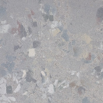 Matte terrazzo-effect porcelain tile with raw gray chips and unpredictable texture, exuding industrial elegance and timeless sophistication.