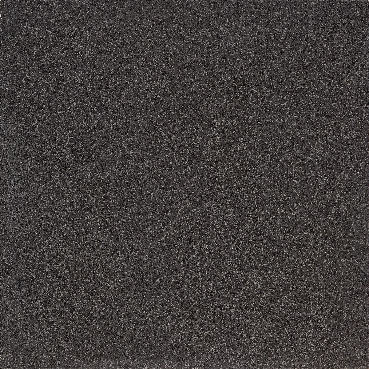 Black terrazzo bullnose trim with glossy porcelain surface and bold concrete-inspired chips, exuding timeless luxury and strength.