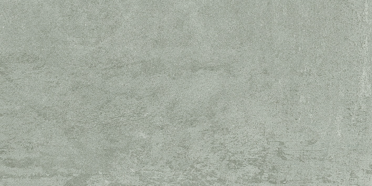Matte silver-gray porcelain tile with a soft bush-hammered texture, evoking timeless industrial elegance and serene minimalist charm.